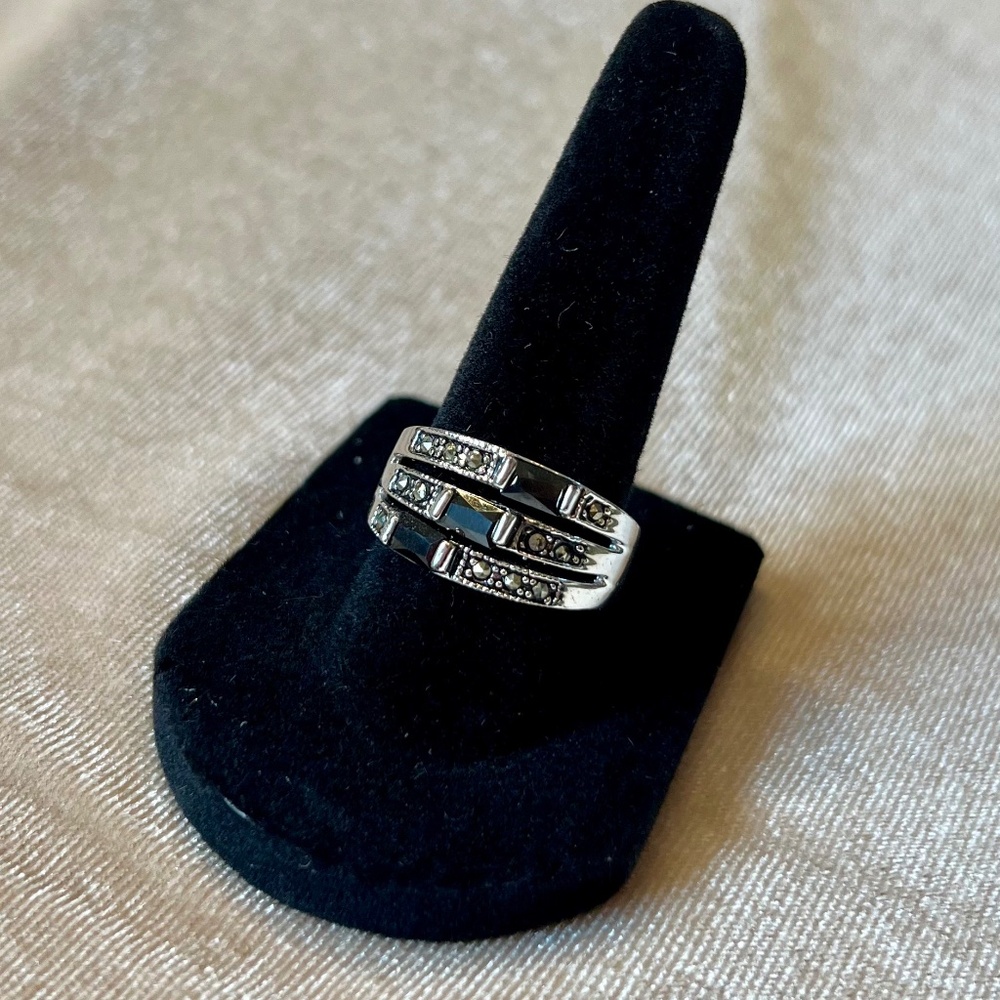 Silver tone ring set with black glass and cz.